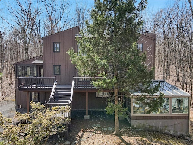 3206 Stonehenge Dr, East Stroudsburg, PA 18301 - back of house with stairway, a wooden deck, and a sunroom