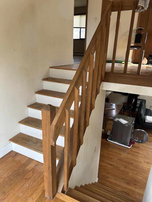 stairs with hardwood / wood-style flooring