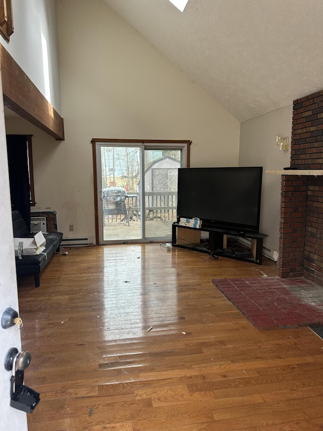 living room with high vaulted ceiling, a baseboard radiator, a textured ceiling, and wood finished floors