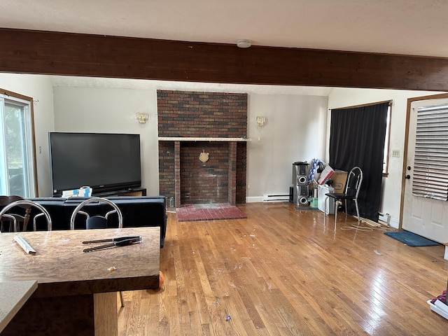 living room with baseboards, a fireplace, hardwood / wood-style flooring, a baseboard heating unit, and beamed ceiling