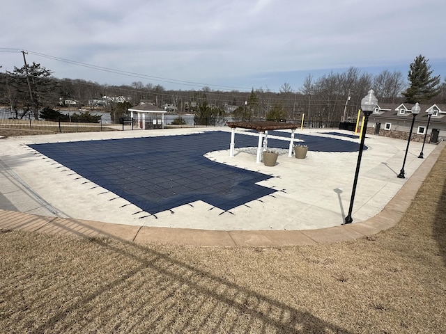 view of swimming pool with fence