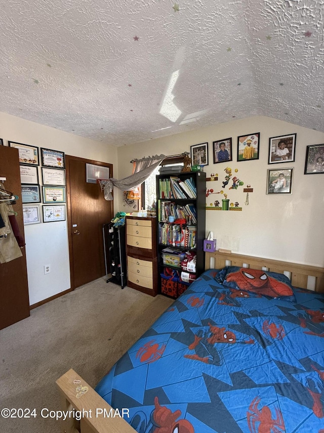 carpeted bedroom with vaulted ceiling, baseboards, and a textured ceiling