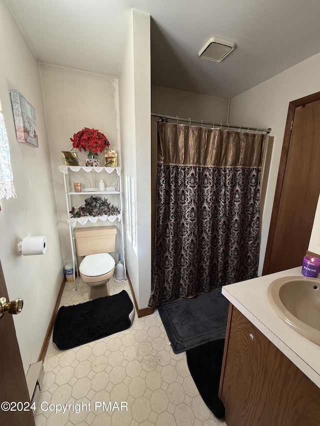 bathroom with a shower with shower curtain, a baseboard radiator, toilet, and vanity