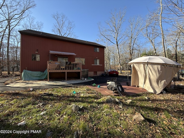 rear view of property featuring crawl space and a deck