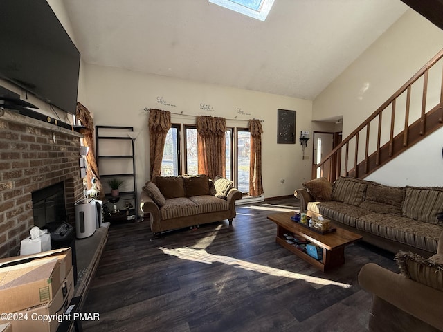 living area with high vaulted ceiling, wood finished floors, stairway, a skylight, and a fireplace