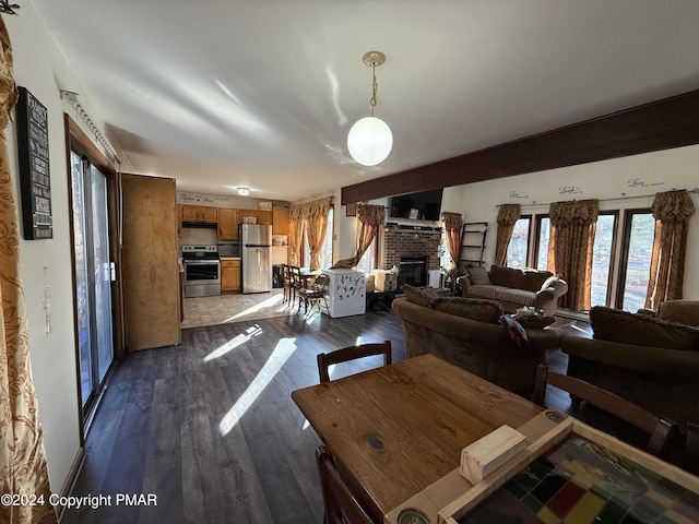 living area featuring a fireplace and dark wood-style flooring