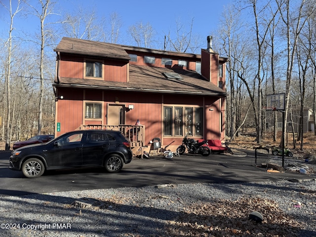 view of front of property featuring roof with shingles