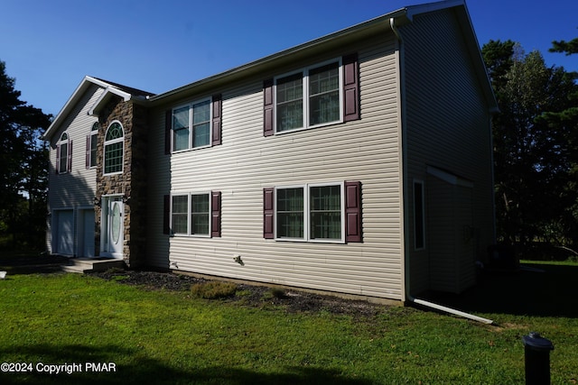 exterior space with a garage and a yard