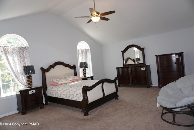 bedroom with ceiling fan, lofted ceiling, and light carpet