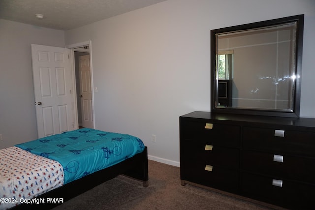 carpeted bedroom with a textured ceiling