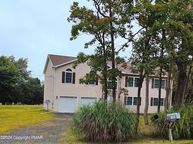 view of front of house featuring a garage and a front lawn