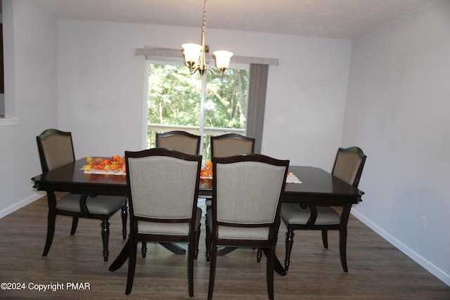 dining space with an inviting chandelier and dark hardwood / wood-style floors