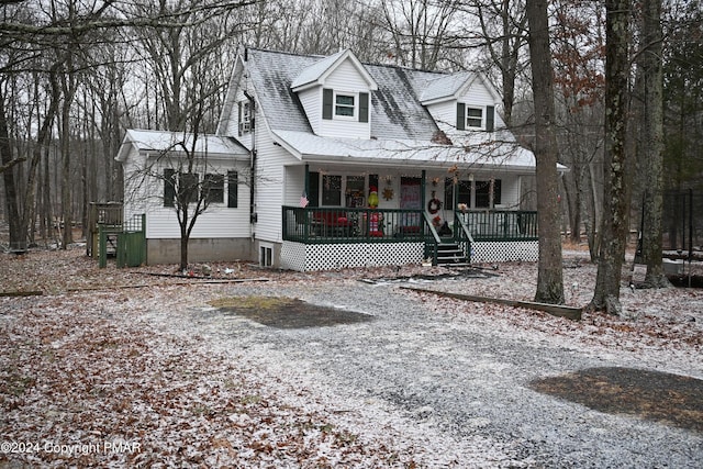 view of front of property featuring covered porch and roof with shingles