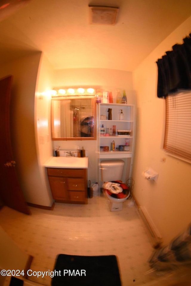 bathroom with toilet, visible vents, and vanity