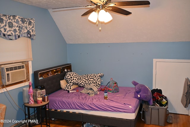 bedroom featuring a textured ceiling, cooling unit, wood finished floors, a ceiling fan, and vaulted ceiling