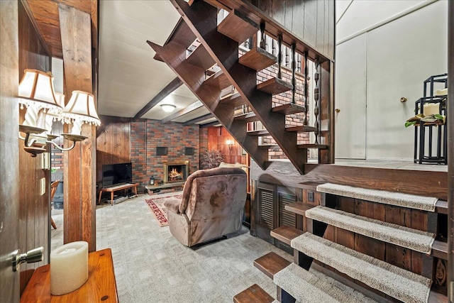 1125 Rhododendron Ln, Pocono Summit, PA 18346 - living room with wooden walls, stairway, a brick fireplace, and carpet