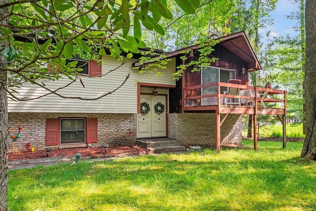 1125 Rhododendron Ln, Pocono Summit, PA 18346 - view of front of home featuring a front lawn, brick siding, and a deck