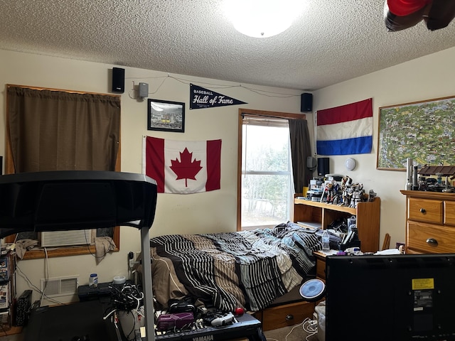 bedroom featuring visible vents and a textured ceiling