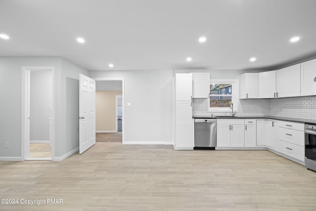 kitchen featuring stainless steel appliances, tasteful backsplash, dark countertops, and a sink