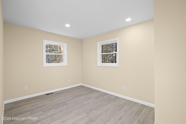 spare room featuring recessed lighting, visible vents, baseboards, and wood finished floors