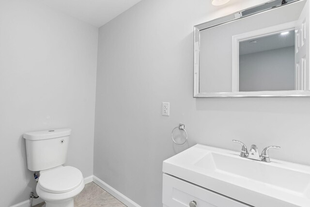 410 Sunset Forest Dr, Hawley, PA 18428 - half bathroom featuring toilet, baseboards, vanity, and tile patterned flooring