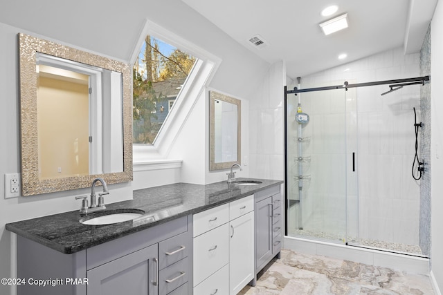 bathroom featuring lofted ceiling, visible vents, a sink, and a shower stall