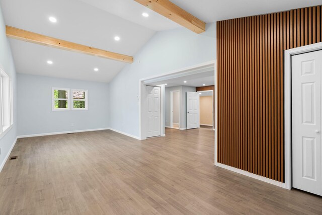 410 Sunset Forest Dr, Hawley, PA 18428 - unfurnished living room featuring beam ceiling, light wood-type flooring, baseboards, recessed lighting, and high vaulted ceiling