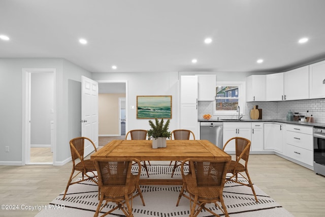 dining area with light wood-type flooring, baseboards, and recessed lighting