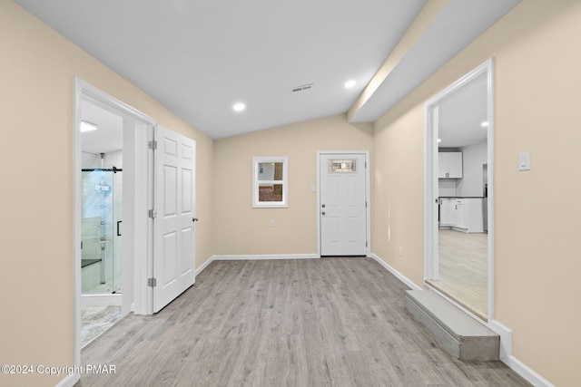 entrance foyer featuring lofted ceiling, light wood-style flooring, recessed lighting, visible vents, and baseboards