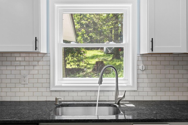 410 Sunset Forest Dr, Hawley, PA 18428 - kitchen view of tasteful backsplash, a sink, white cabinets, and dark stone countertops