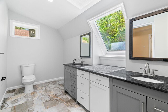 410 Sunset Forest Dr, Hawley, PA 18428 - bathroom with lofted ceiling, plenty of natural light, toilet, double vanity, and baseboards