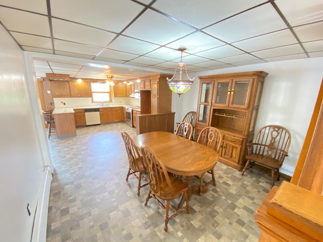 dining area with baseboards and a drop ceiling