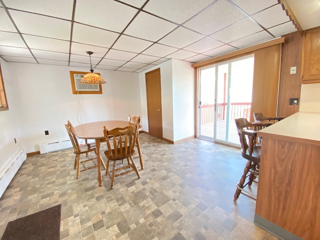 dining area featuring baseboards, a paneled ceiling, and baseboard heating
