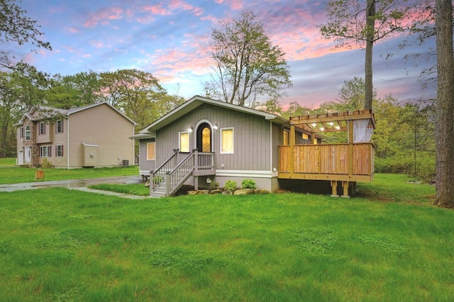 view of front of property with a front yard and a deck