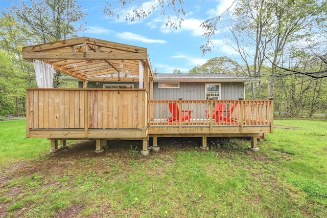 back of property featuring a deck and a lawn