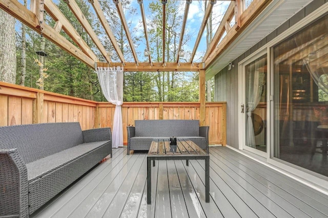 wooden terrace with an outdoor living space