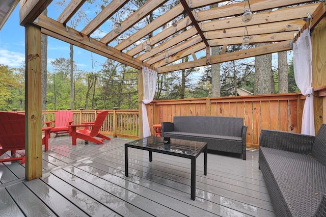 wooden deck with an outdoor hangout area and a pergola