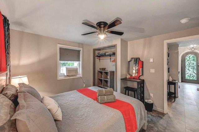 bedroom with multiple windows, a ceiling fan, and baseboards