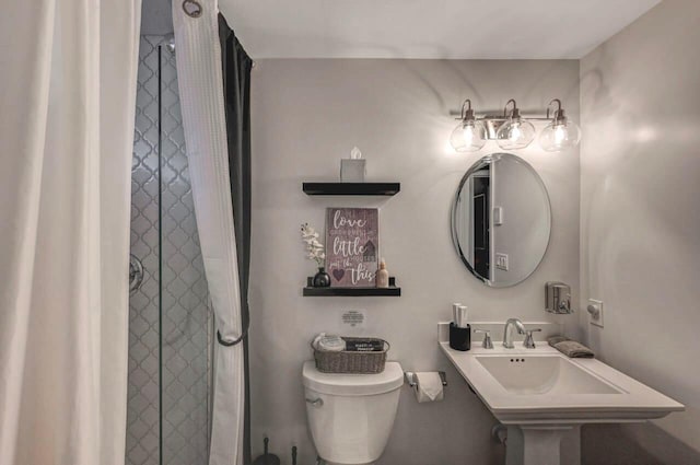 bathroom featuring toilet and a shower with curtain