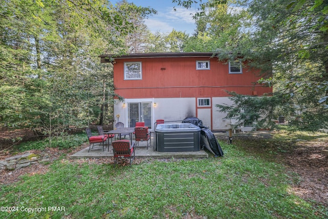 back of property with central air condition unit, a yard, and a patio