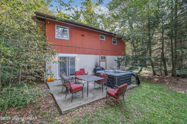 rear view of house with a patio area and a lawn