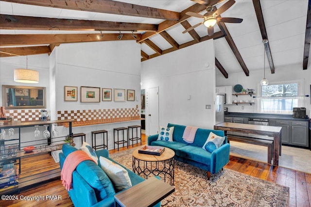 living room featuring a ceiling fan, wood-type flooring, beamed ceiling, and high vaulted ceiling