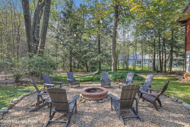 view of yard with a patio and an outdoor fire pit