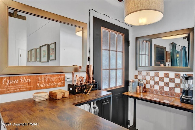 kitchen with tasteful backsplash and butcher block countertops