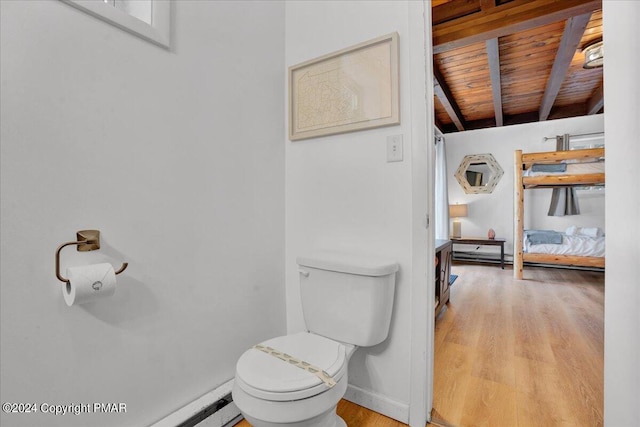 half bathroom featuring wooden ceiling, toilet, wood finished floors, baseboards, and beam ceiling