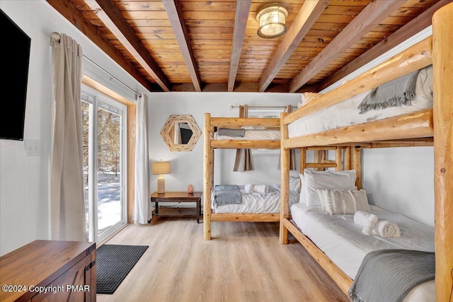 bedroom featuring wood ceiling, beam ceiling, and light wood finished floors