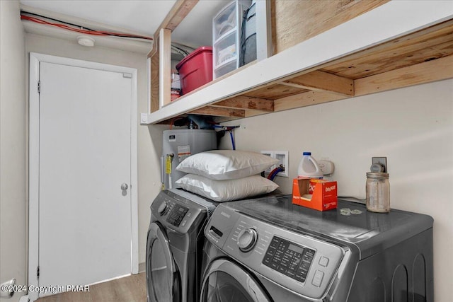 laundry room with washing machine and dryer, laundry area, water heater, and wood finished floors