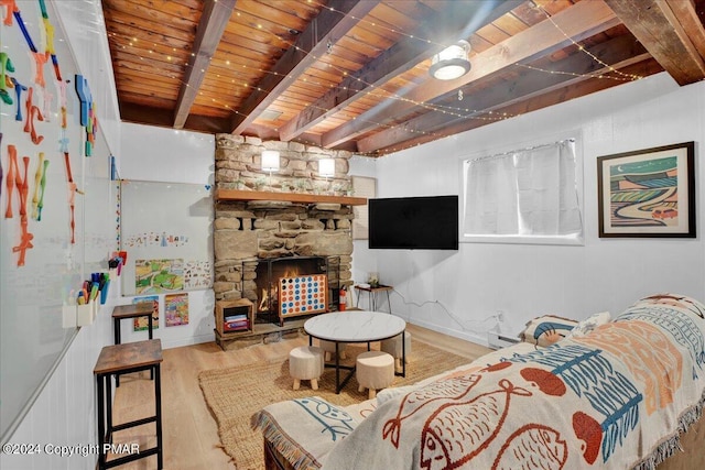 living area featuring a fireplace, wooden ceiling, wood finished floors, and beam ceiling