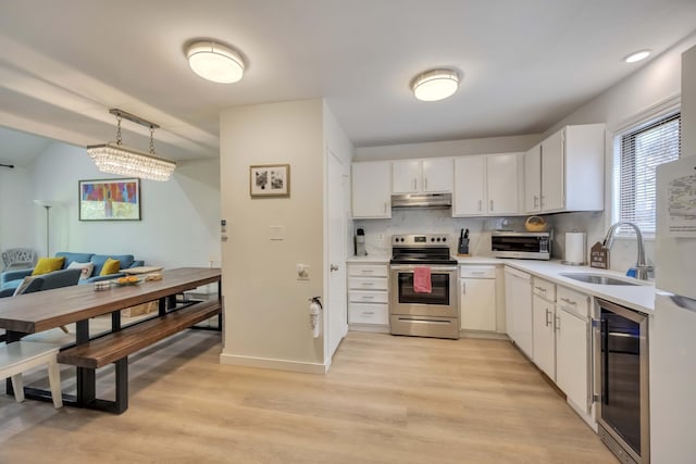 130 Cross Country Ln, Tannersville, PA 18372 - kitchen featuring stainless steel electric stove, a sink, wine cooler, light wood-style floors, and under cabinet range hood