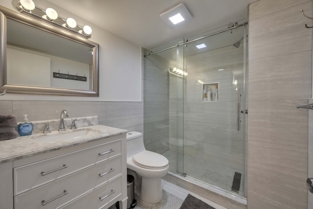 130 Cross Country Ln, Tannersville, PA 18372 - bathroom featuring tile walls, toilet, a shower stall, vanity, and tile patterned flooring